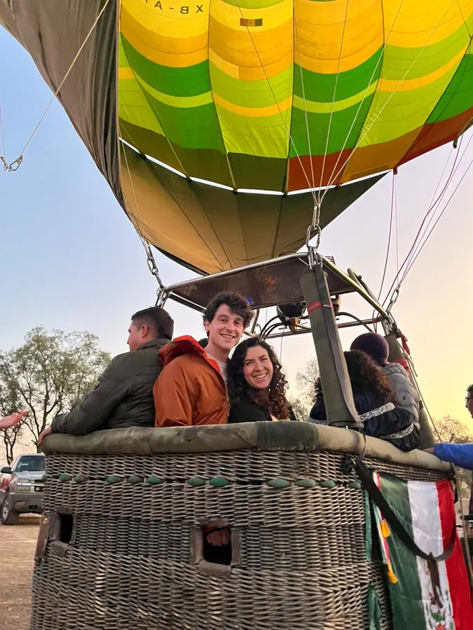Squeezed into the basket of a hot air balloon at dawn