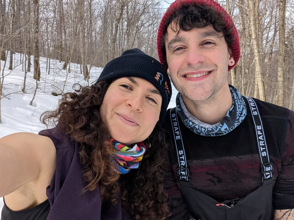 Two cold grins among the birches on a ski day