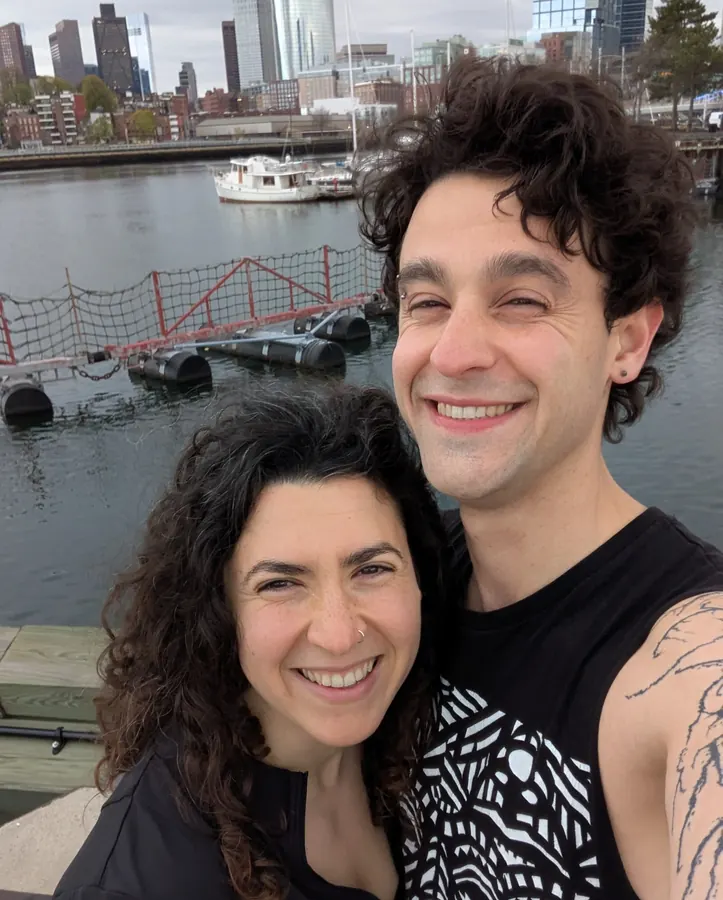 By the water with the Boston skyline behind us