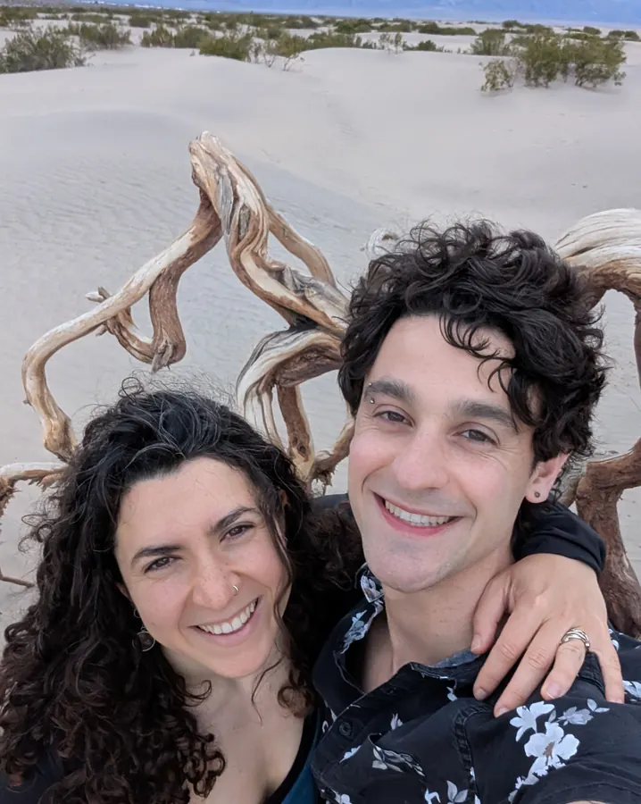 In the sand dunes with a twist of driftwood behind us